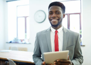 Successful employer with tablet looking at camera
