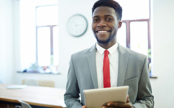 Manager in business attire Successful employer with tablet looking at camera