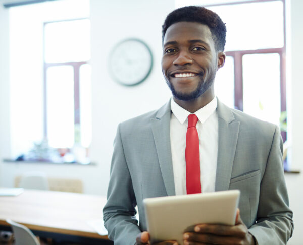 Successful employer with tablet looking at camera